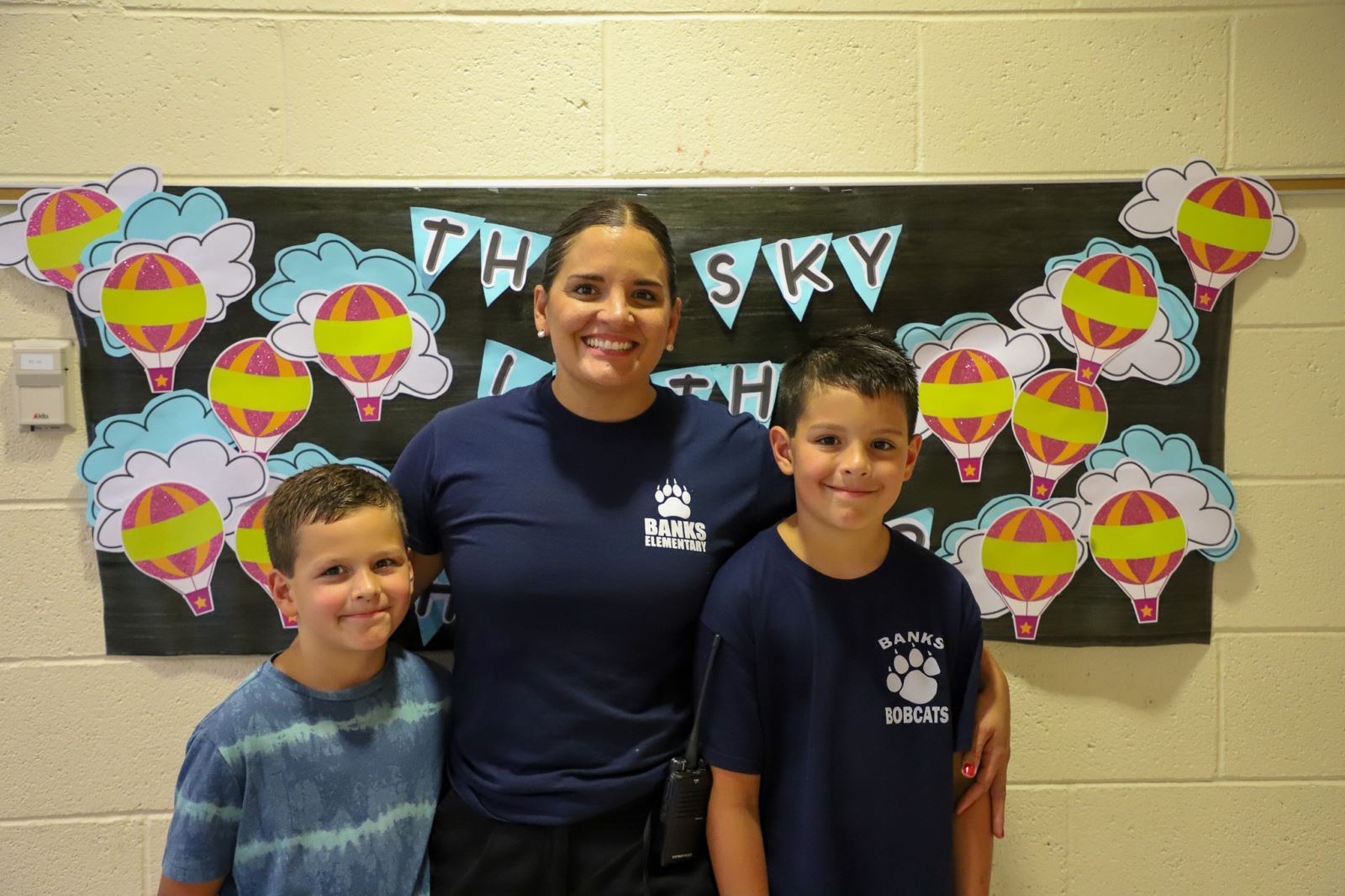 Two Banks Elementary students pose for a photo with a staff member on the first day