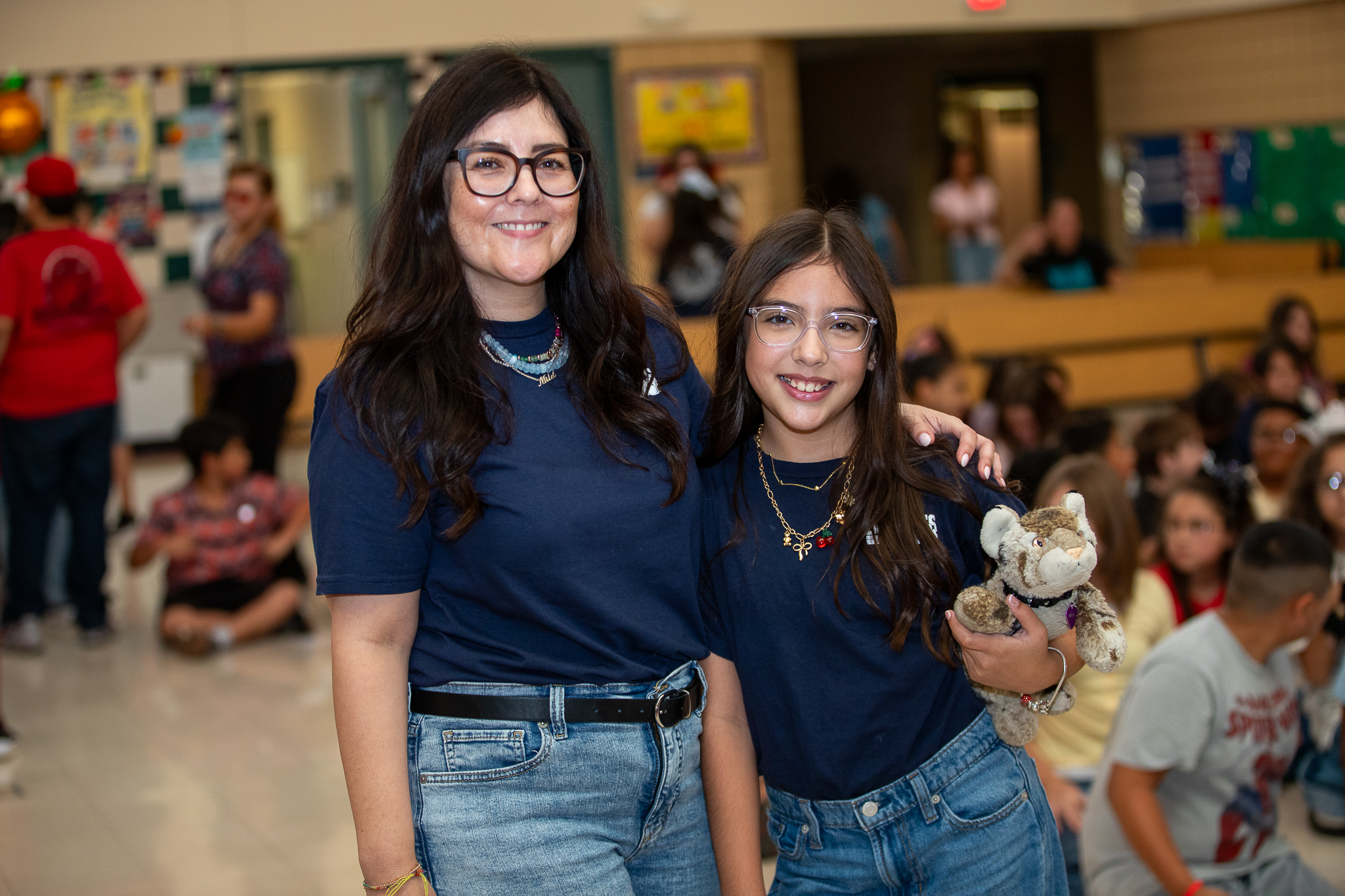 A woman and her daughter pose in matching outfits