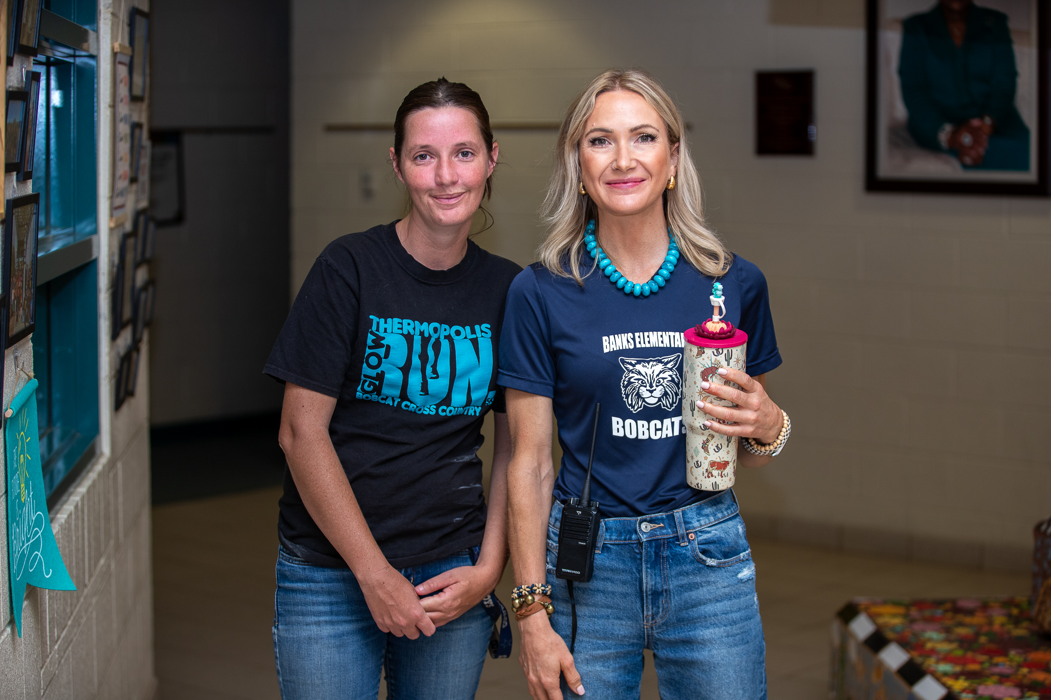 Two women smile in the front office